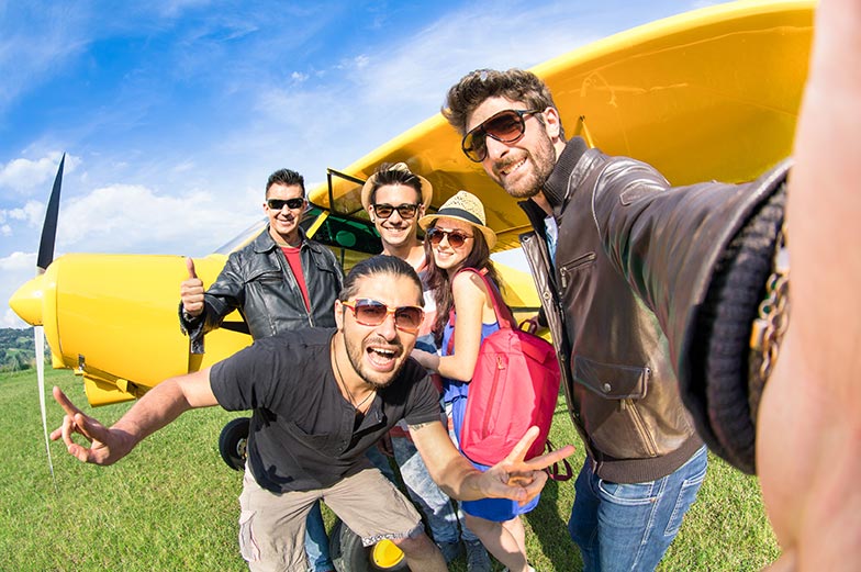 friends taking selfie with an airplane