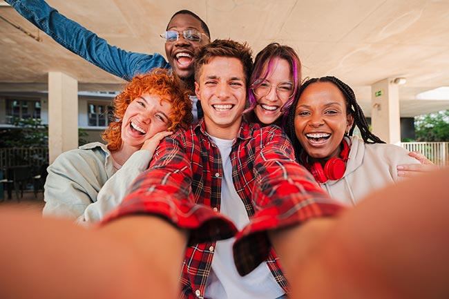 Joyful group of multiracial friends enjoying a fun selfie moment together