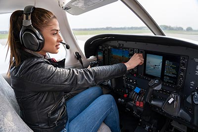 Woman Pilot With Headset in the Cockpit
