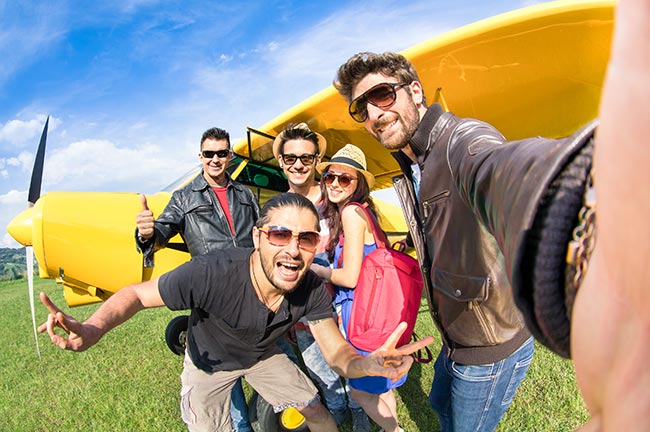 Best friends taking selfie with ultra light airplane