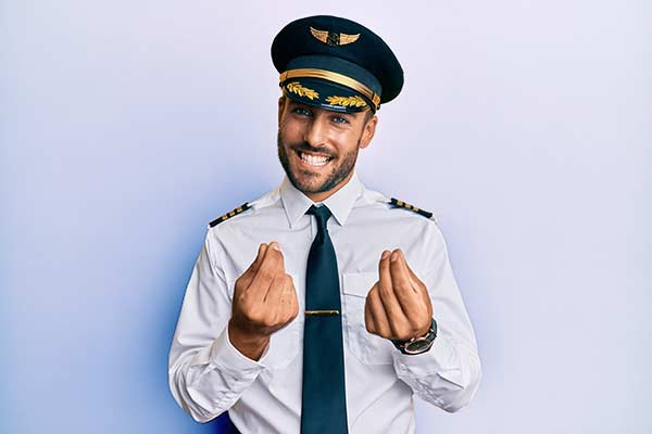 airplane pilot doing money gesture with hands
